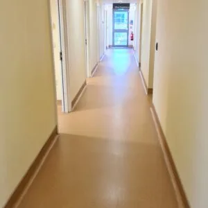 Beige vinyl safety flooring in a corridor, deep cleaned and polished