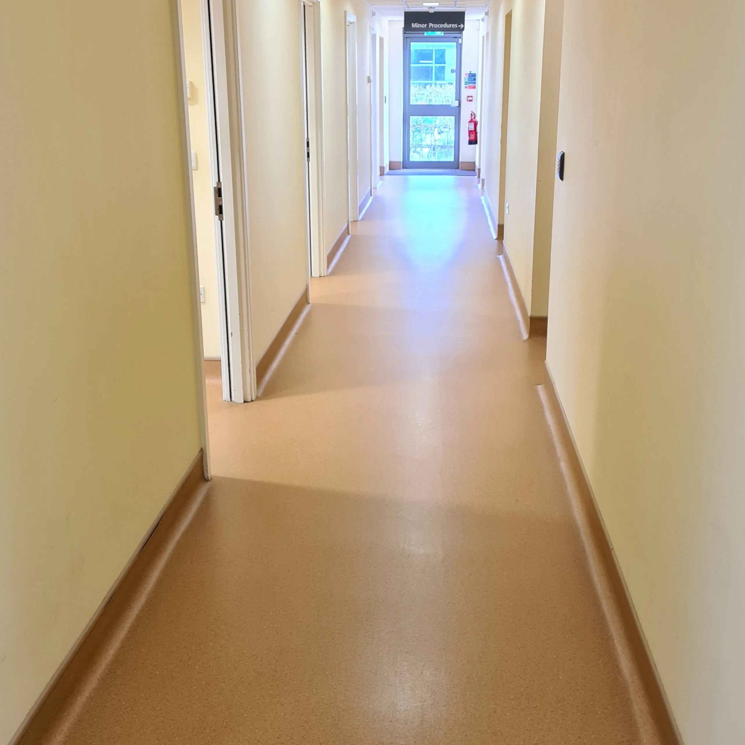 Beige vinyl safety flooring in a corridor, deep cleaned and polished
