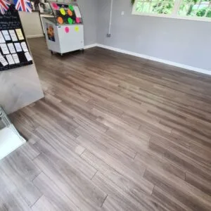Grey wood-effect LVT floor after deep cleaning and resealing in a bright room