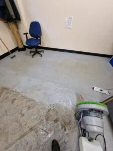Commercial safety flooring being deep cleaned with a scrubber machine, before and after contrast visible