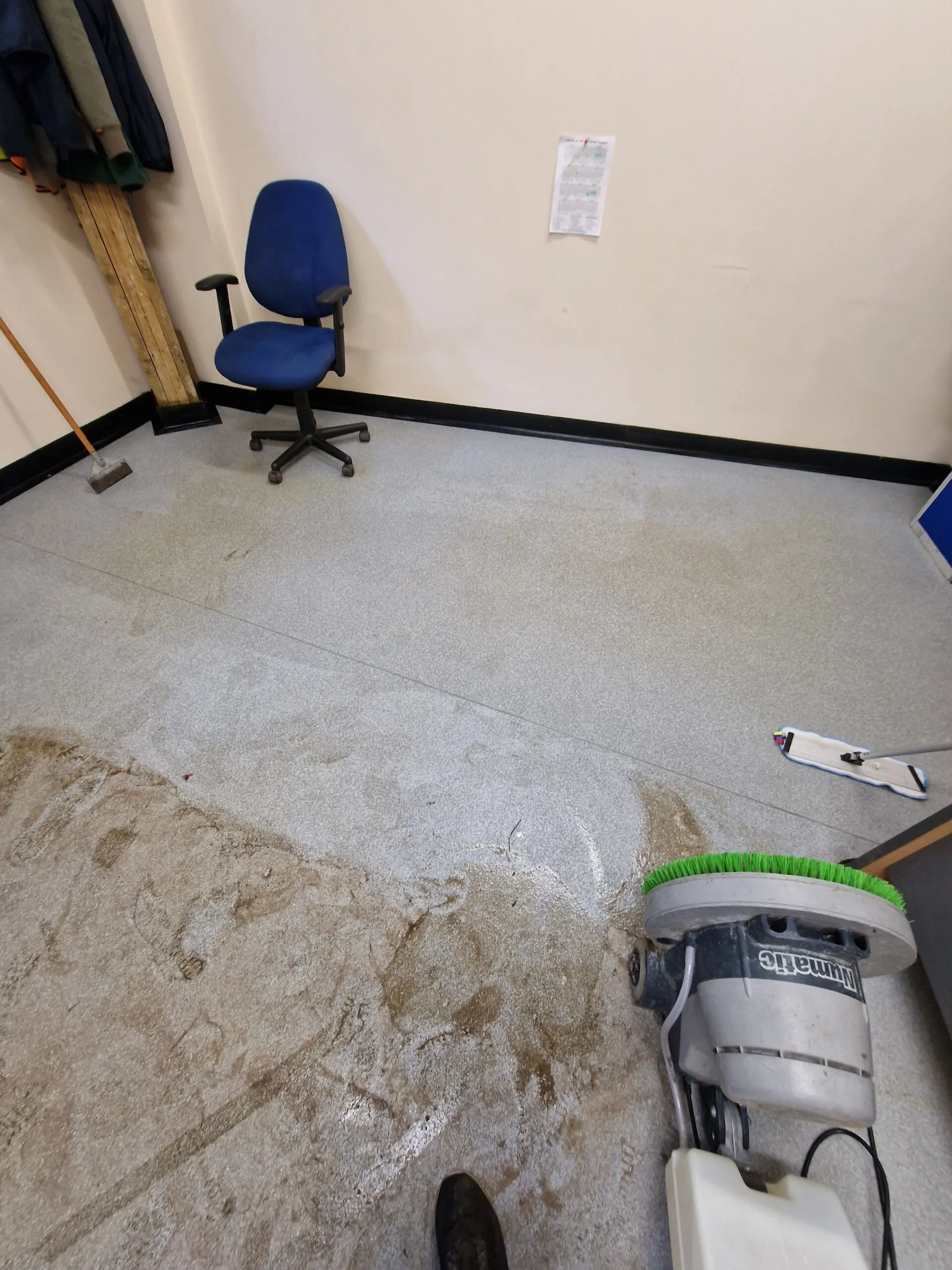 Commercial safety flooring being deep cleaned with a scrubber machine, before and after contrast visible