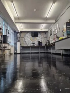 High-gloss black safety vinyl flooring in a commercial salon unit