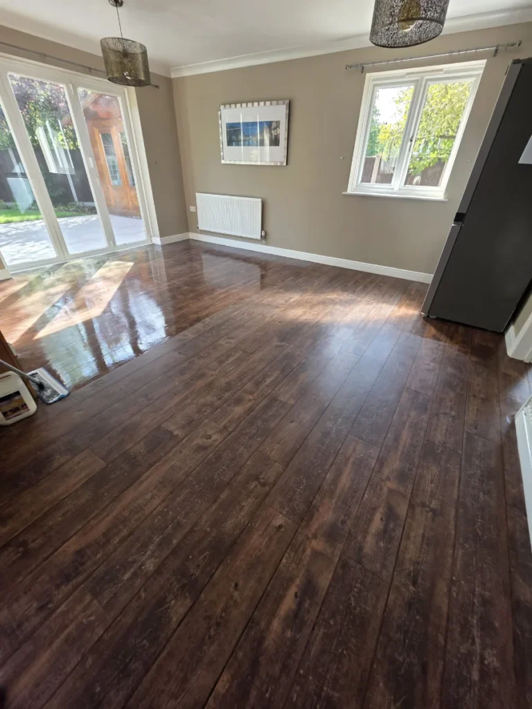 Freshly deep-cleaned wood-effect LVT floor with a restored sheen in an Essex kitchen-diner